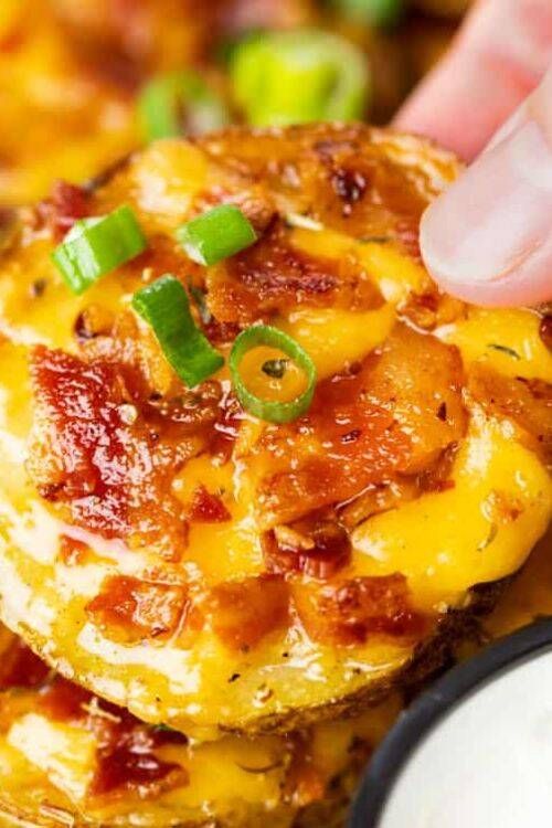 Crispy loaded potato skins topped with bacon, cheddar, and sour cream